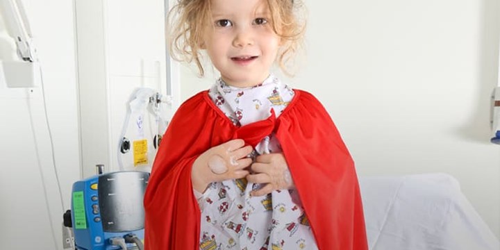 Girl standing hospital bed.jpg