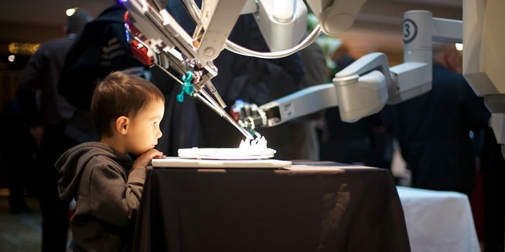 Young boy with Da Vinci robot2.JPG