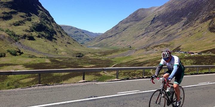 Cyclist on road sun hills.jpg